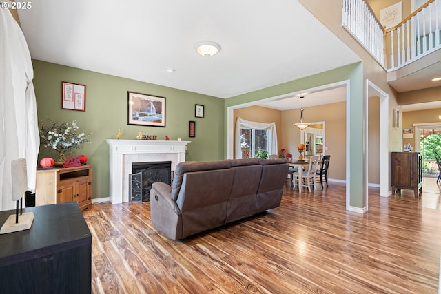 2855 NW Orchard Heights Ave, Albany, OR 97321 - living room featuring light wood finished floors, a tile fireplace, and baseboards