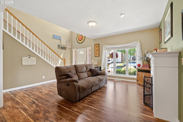 2855 NW Orchard Heights Ave, Albany, OR 97321 - living area with dark wood-type flooring, stairs, a textured ceiling, and baseboards