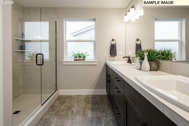 4688 NW 71st Ave, Camas, WA 98607 - full bath featuring baseboards, double vanity, a sink, and a shower stall