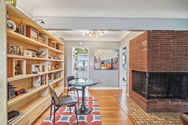 2025 SE Caruthers St Unit 19, Portland, OR 97214 - living room featuring wood finished floors and a brick fireplace