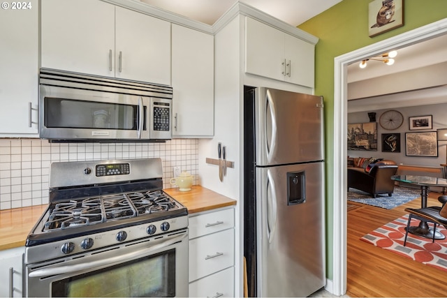 2025 SE Caruthers St Unit 19, Portland, OR 97214 - dining space featuring wood finished floors and a fireplace