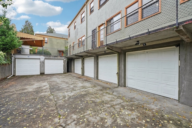 2025 SE Caruthers St Unit 19, Portland, OR 97214 - laundry area with stacked washer and clothes dryer, wood finished floors, and cabinet space