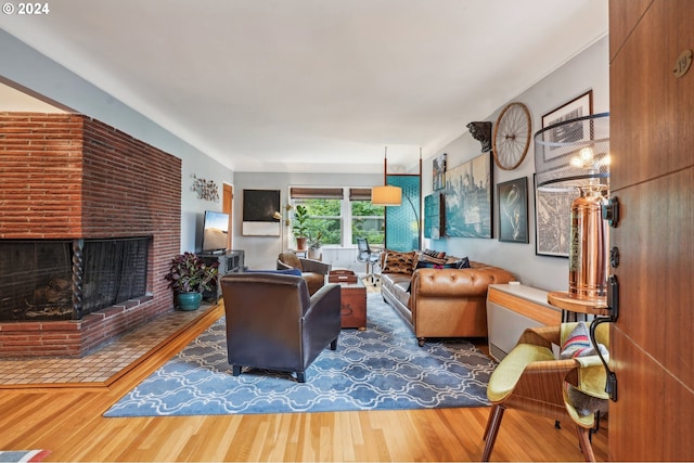 2025 SE Caruthers St Unit 19, Portland, OR 97214 - living room featuring wood finished floors and a brick fireplace