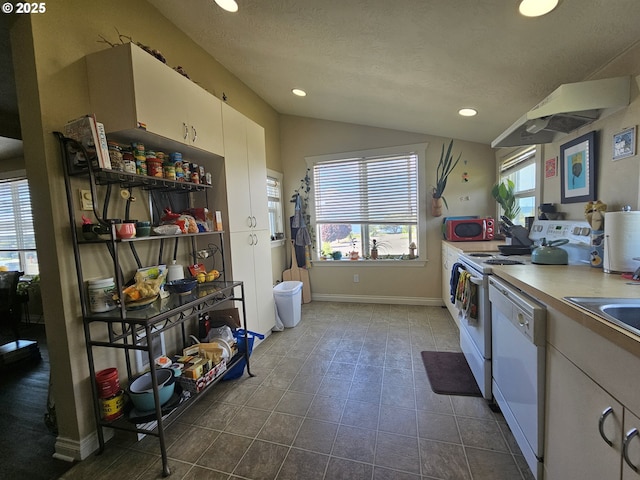 110 2nd St, Astoria, OR 97103 - kitchen featuring electric range, dishwasher, lofted ceiling, recessed lighting, and baseboards