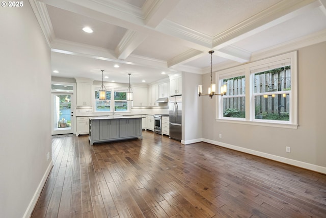 2760 SW Sylvania Ter, Portland, OR 97219 - kitchen featuring appliances with stainless steel finishes, a chandelier, under cabinet range hood, ornamental molding, and white cabinets