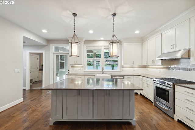 2760 SW Sylvania Ter, Portland, OR 97219 - kitchen featuring gas range, under cabinet range hood, decorative backsplash, white cabinetry, and a center island