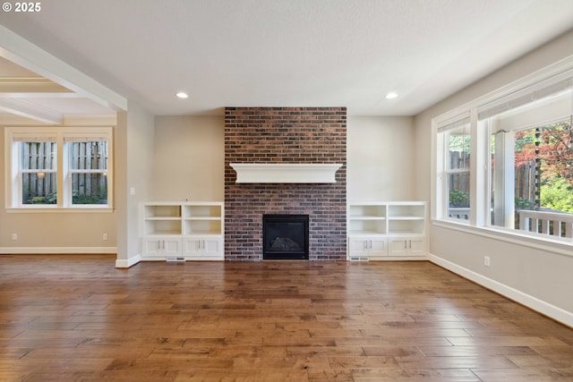 2760 SW Sylvania Ter, Portland, OR 97219 - unfurnished living room with hardwood / wood-style floors, a brick fireplace, and recessed lighting