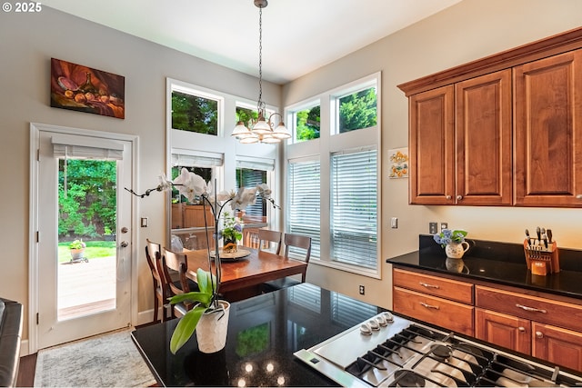 1406 NW Slocum Way, Portland, OR 97229 - kitchen featuring stainless steel gas cooktop, brown cabinetry, hanging light fixtures, and a chandelier