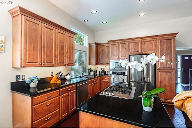 1406 NW Slocum Way, Portland, OR 97229 - kitchen with appliances with stainless steel finishes, dark wood-style floors, recessed lighting, dark countertops, and brown cabinets
