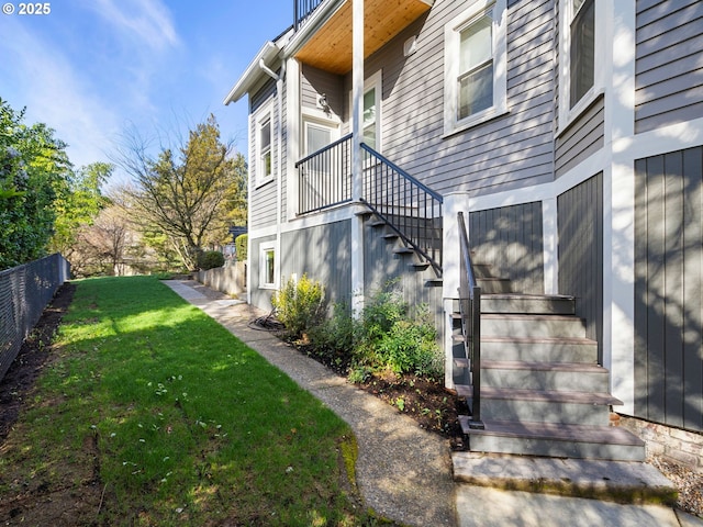 view of yard with stairway, fence, and elevator