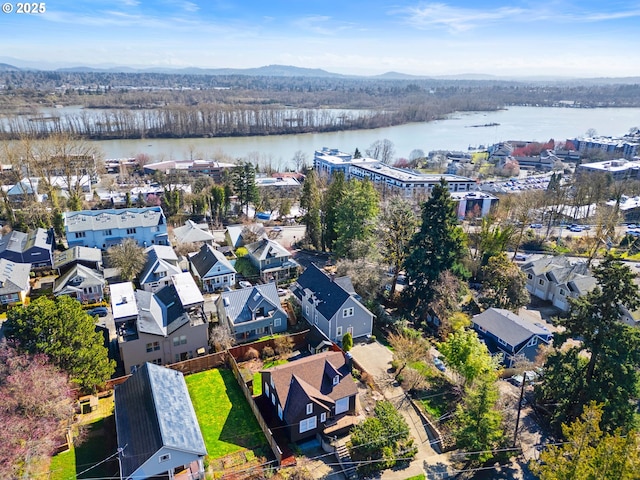 birds eye view of property featuring a water view and a view of trees