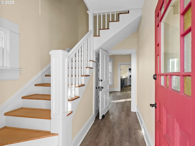 stairway featuring wood finished floors and baseboards