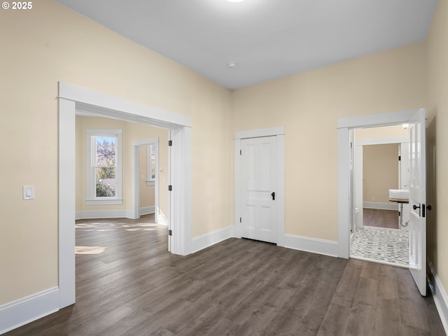 interior space featuring dark wood finished floors and baseboards