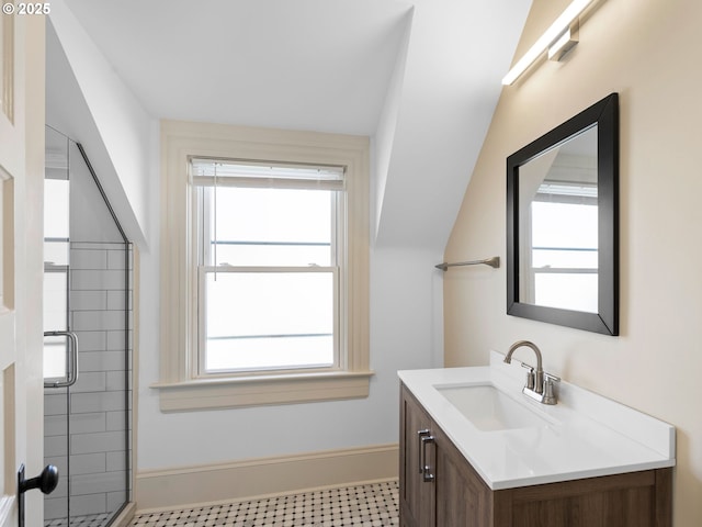 full bath with vanity, a shower stall, a wealth of natural light, and baseboards