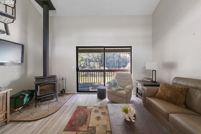 43605 State Highway 38 Unit 9, Reedsport, OR 97467 - living area with a wood stove, wood finished floors, and baseboards
