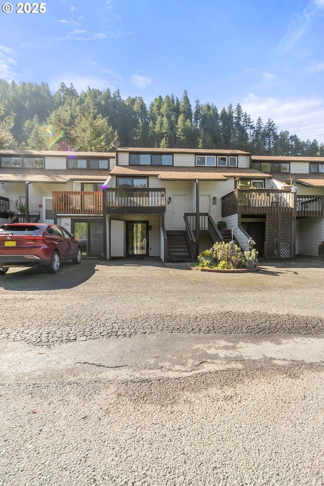 townhome / multi-family property featuring stairway and a wooden deck