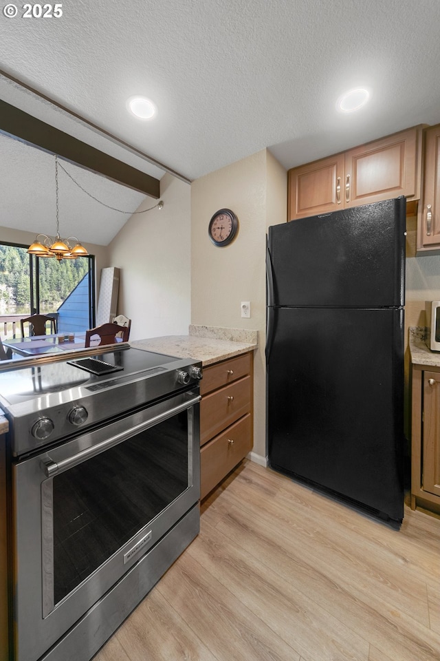 43605 State Highway 38 Unit 9, Reedsport, OR 97467 - kitchen with appliances with stainless steel finishes, light wood finished floors, a textured ceiling, decorative light fixtures, and light stone counters