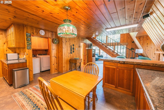 5920 Elkhead Rd, Yoncalla, OR 97499 - dining room with washer and dryer, wood walls, wood ceiling, a chandelier, and stairway