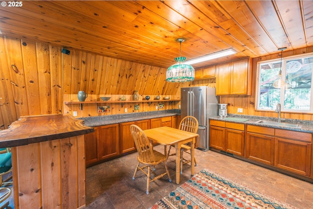 5920 Elkhead Rd, Yoncalla, OR 97499 - kitchen featuring a sink, freestanding refrigerator, wooden ceiling, wooden walls, and brown cabinetry