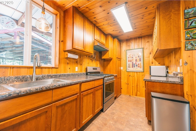 5920 Elkhead Rd, Yoncalla, OR 97499 - kitchen with stainless steel range with gas cooktop, a sink, brown cabinetry, wooden walls, and wood ceiling