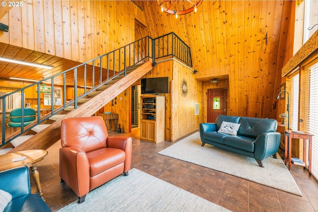 5920 Elkhead Rd, Yoncalla, OR 97499 - living area with a high ceiling, wooden walls, stairs, and stone finish flooring