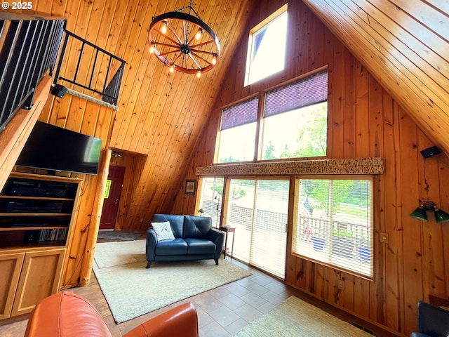 5920 Elkhead Rd, Yoncalla, OR 97499 - living area featuring high vaulted ceiling, wooden walls, healthy amount of natural light, tile patterned floors, and a chandelier