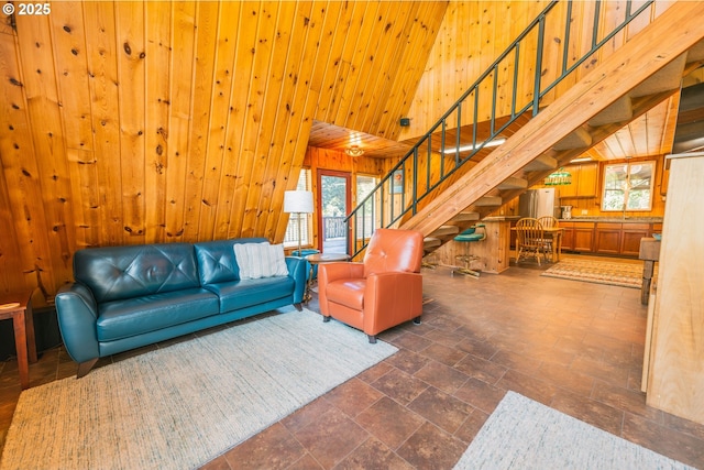5920 Elkhead Rd, Yoncalla, OR 97499 - living area with wood walls, stairway, stone tile flooring, and a high ceiling