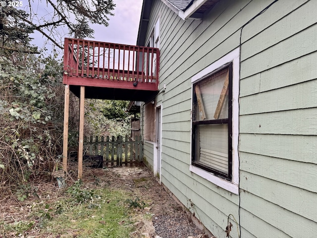 view of side of property featuring fence