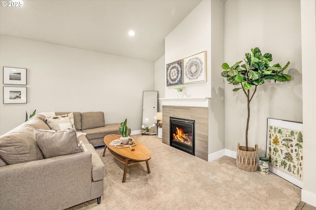 living area with carpet floors, a fireplace, recessed lighting, vaulted ceiling, and baseboards