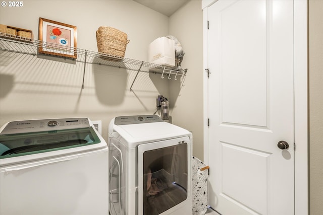 clothes washing area with laundry area and washer and clothes dryer