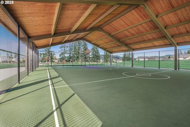 view of sport court featuring community basketball court, fence, and a wealth of natural light