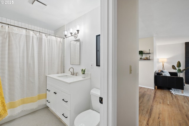 bathroom featuring toilet, hardwood / wood-style flooring, a chandelier, and vanity