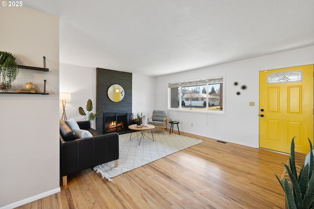 living room with hardwood / wood-style floors and a fireplace