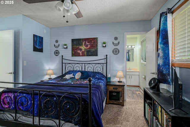 7360 SE Imperial Ct, Milwaukie, OR 97222 - carpeted bedroom featuring a textured ceiling, connected bathroom, a ceiling fan, and wood finished floors