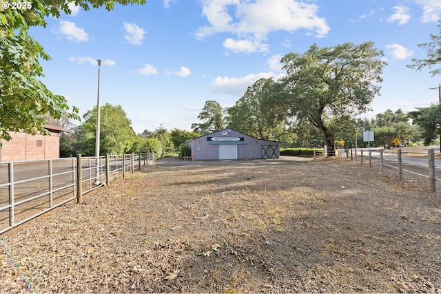 view of yard featuring an outbuilding and a rural view