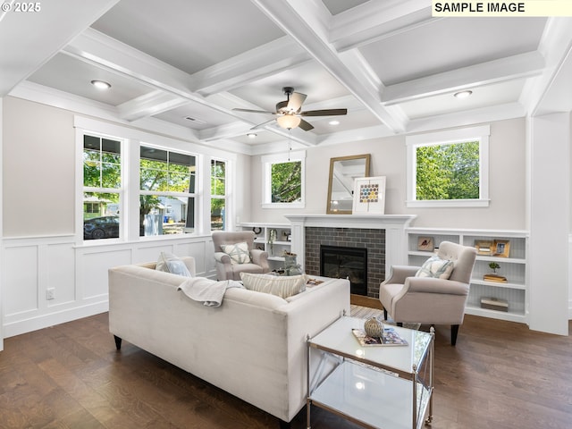 living room with beamed ceiling, dark hardwood / wood-style floors, coffered ceiling, and a fireplace