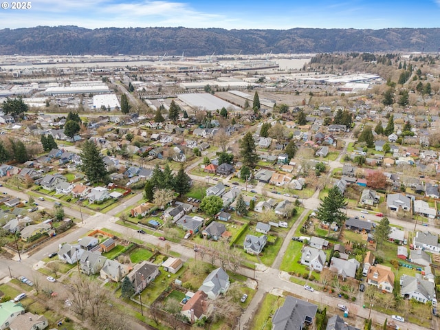 drone / aerial view featuring a residential view and a mountain view