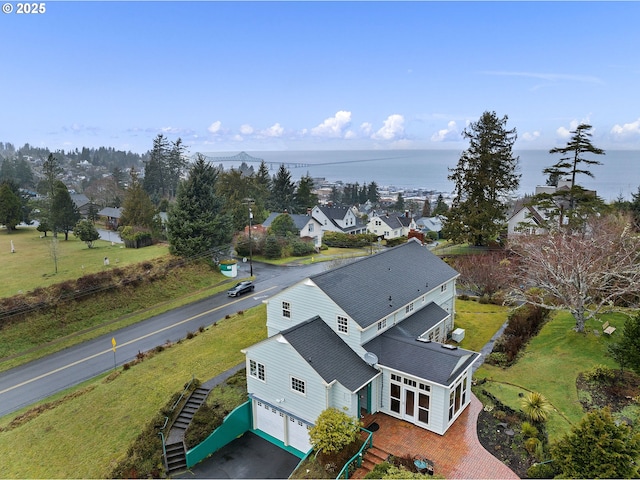 birds eye view of property with a water view and a residential view