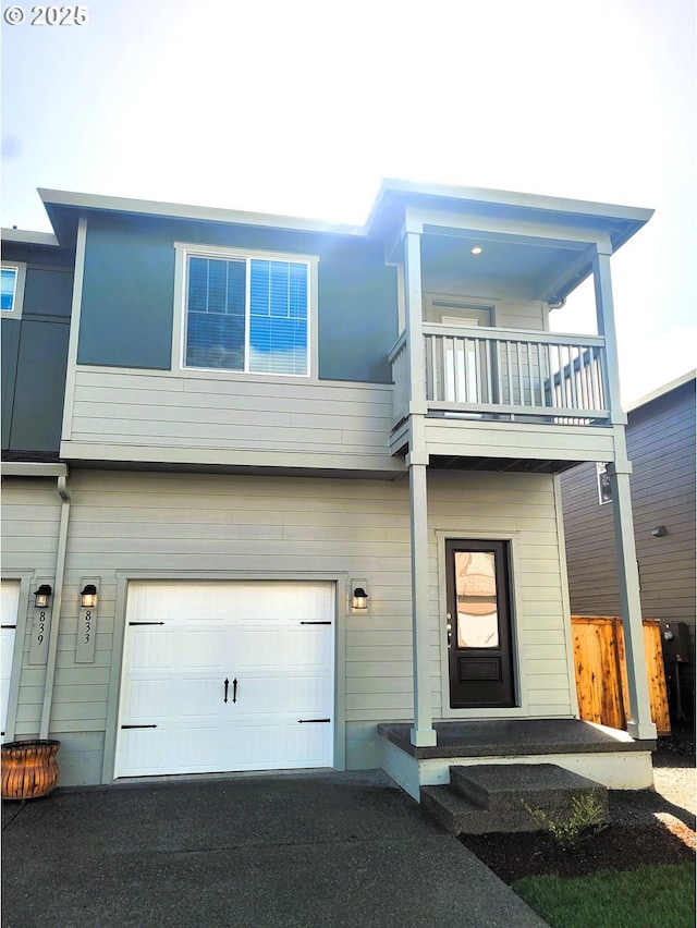 833 NE 14th St, Battle Ground, WA 98604 - view of front of house featuring a balcony, a garage, and asphalt driveway