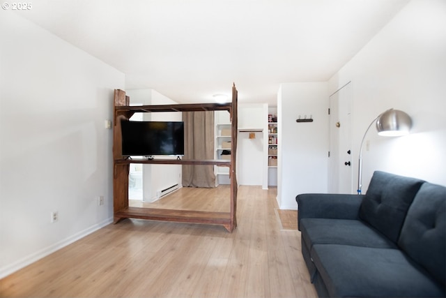 unfurnished living room featuring light wood-type flooring, baseboards, and a baseboard radiator