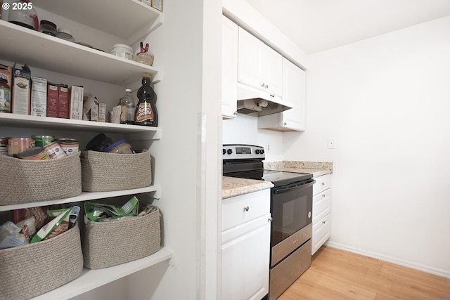 kitchen featuring baseboards, white cabinets, electric stove, under cabinet range hood, and light wood-type flooring