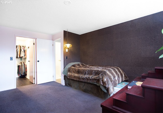 bedroom with carpet and a textured ceiling