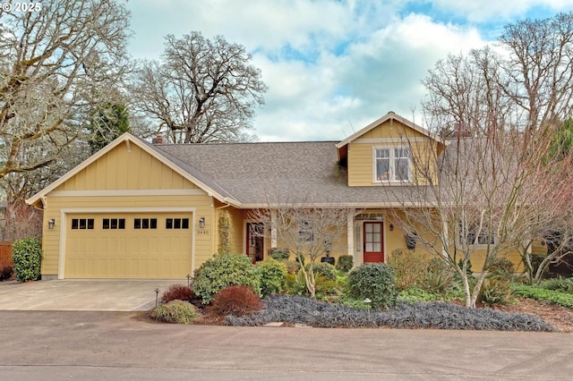 view of front facade with an attached garage, driveway, and roof with shingles