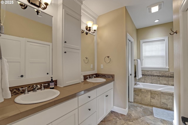 bathroom featuring a sink, a relaxing tiled tub, baseboards, and double vanity