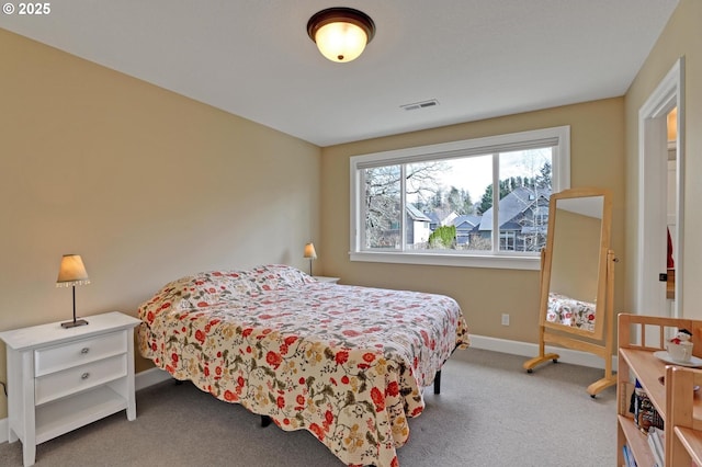 carpeted bedroom featuring baseboards and visible vents