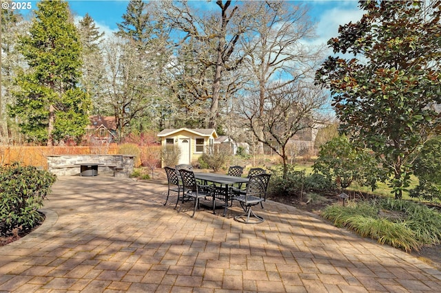 view of patio / terrace featuring outdoor dining space and an outdoor structure