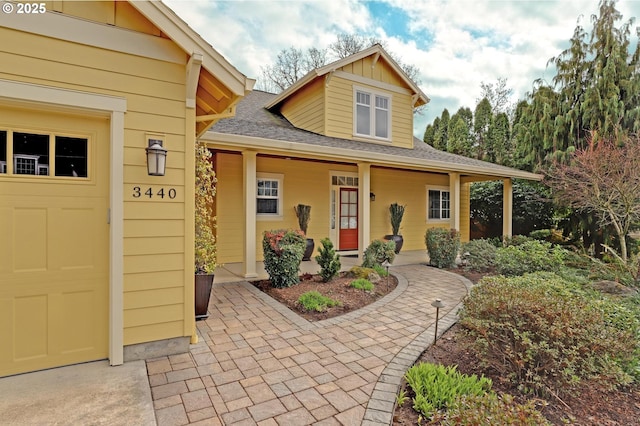 exterior space featuring a porch and a garage