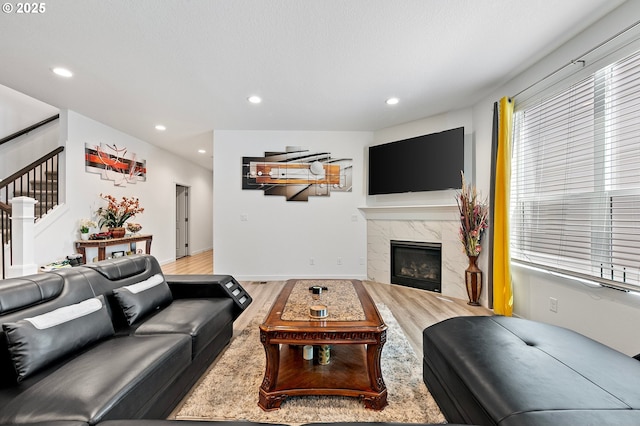 2504 Brackenfern Rd, Eugene, OR 97403 - living area featuring wood finished floors, recessed lighting, stairs, and a premium fireplace