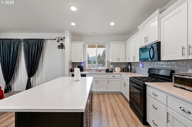 2504 Brackenfern Rd, Eugene, OR 97403 - kitchen featuring black appliances, a sink, light countertops, a kitchen island, and recessed lighting