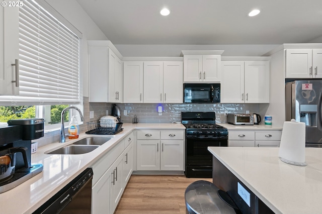 2504 Brackenfern Rd, Eugene, OR 97403 - kitchen featuring black appliances, a sink, white cabinetry, light countertops, and recessed lighting